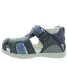 Blue closed toe sandals for a boy wiith ankle support 